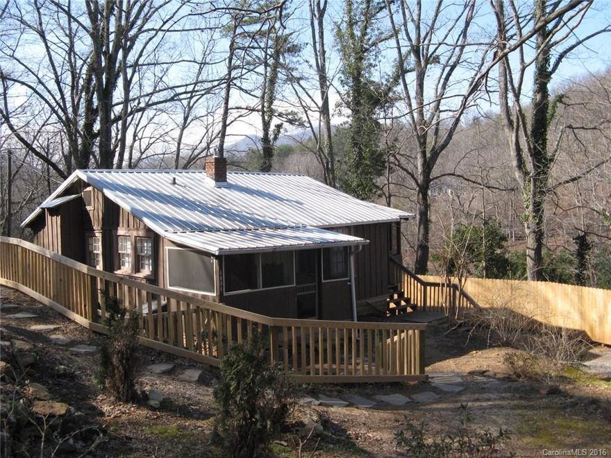 Early Tryon cabin with over 800 sq. ft. under roof. Mountain views.   Lower level walk-out could be finished for additional bedroom, bath or game room.  Close to downtown Tryon.  Workshop included.