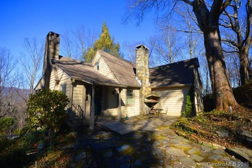 CUTE, CUTE, CUTE! Charming 1940's cottage w/Blue Ridge Mtn view w/in the village of Tryon. 3 levels, 3 beds, 3 baths & 3 flagstone patio's. Private & hard to find! Screen porch overlooking the mtns, library w/stone fp & window seat, Living rm w/stone fp is open to library & dining area w/built-in storage. Kitchen has center island & patio access. The storybook setting will make you want to dine outside on every pretty day! Close to downtown & minutes from Tryon International Equestrian Center.