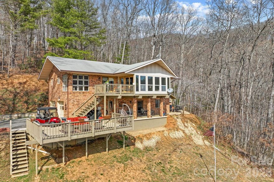 Come home to Springdale Resort! Nestled on approximately 4 acres, this 3-bedroom, 2-bath mountain retreat offers stunning year-round mountain views and the peaceful setting that makes Western North Carolina living so special. A truly unique feature of this property is its private vineyard, boasting over 30 established grape plants, perfect for hobby winemakers, gardening enthusiasts, or anyone who appreciates a distinctive mountain property. Surrounded by nature, the property provides the perfect blend of privacy, space, and scenic beauty. Located within the Springdale community, this home is just a short golf cart ride to the resort amenities at Springdale Resort, where you can enjoy the 18-hole golf course, the award-winning Rocky Face Tavern, a 24/7 fitness center, pool, hot tub, and the pro shop.