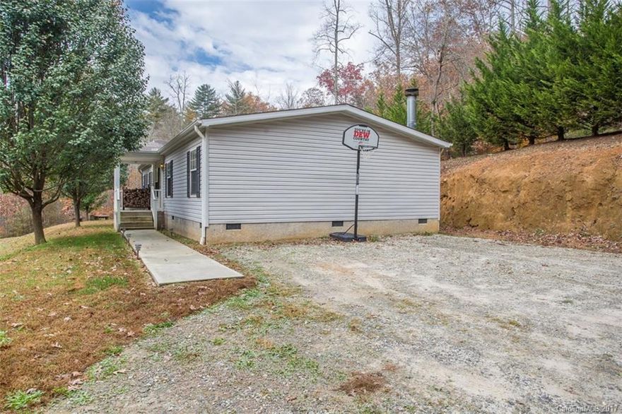 Move in ready! This well maintained home sits in a great location central to both Brevard and Rosman. 2 bedrooms, plus another room with closet. (2 bed septic). The kitchen is a cooks delight, with lots of cabinets and counter space. Master bath features separate shower and garden tub. You will love having two living areas, and the den features a beautiful wood burning fireplace. Come see this home today!