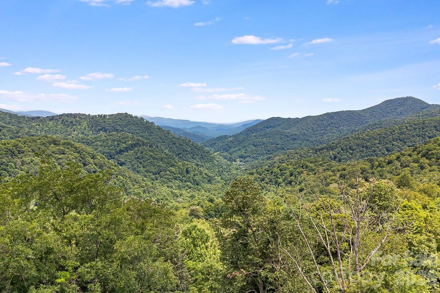 Find your sanctuary on lots #16 and #17 in The Preserve at Wolf Laurel. At nearly 4,000 feet this 4.18-acre double lot homesite offers cool summer temperatures and panoramic views of the Bald Mountains. The gated Preserve is bordered by conservation land with miles of hiking and ATV trails and offers quick access to the Appalachian Trail and ski slopes. Residents may join Wolf Laurel Country Club, an 18-hole course rising from 3,600 to nearly 4,800 feet—one of the highest east of the Mississippi—and enjoy fine dining and a friendly membership. The club also features a 24/7 fitness center with strength and cardio equipment, group classes and a yoga pavilion. Optional Village Club membership adds a heated pool, tennis, pickleball, multi-sport courts, trout pond and playgrounds. Social events foster friendships. Burnsville is 20 minutes away and Asheville roughly 45 minutes. Within the gates enjoy a stocked trout pond and 50 miles of trails. Build your dream retreat in this special mountain community.