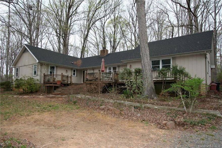 4 BR ranch on over 1 acre! Large front deck. Separate 2 story building previously used as an art studio. Private wooded lot in desirable area. Updating needed, Sold "as-is".