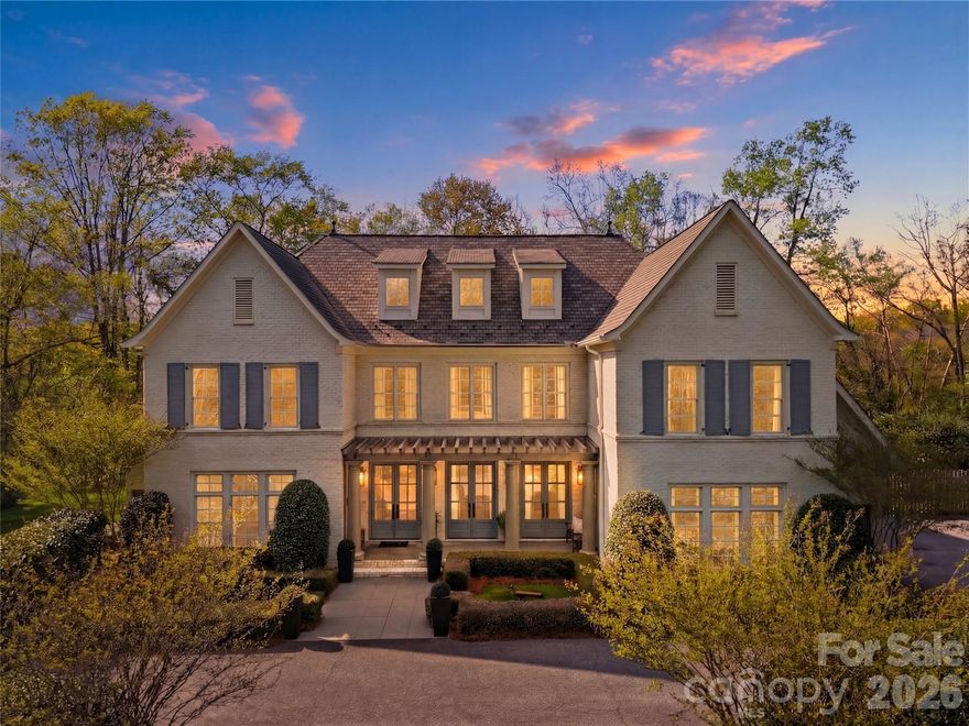 Step into a home where elegance meets everyday living—where every detail has been thoughtfully designed to evoke warmth, beauty, and timeless charm. Inspired by the romance and grace of Pride and Prejudice, this custom-built residence by Higgins Construction offers a lifestyle that encourages you to slow down, gather often, and truly feel at home. Nestled on over two private acres in the highly sought-after Pines II community, this property blends space, serenity, and refined living. Expansive windows fill the home with natural light, highlighting rich hardwood floors, soaring ceilings, and exquisite custom millwork that define its character.
At the heart of the home, the great room invites connection—perfect for cozy evenings by the stone fireplace or lively gatherings that flow seamlessly into the chef’s kitchen. Designed for both function and beauty, the kitchen features a keeping room, generous island, high-end Jenn-Air appliances, and thoughtfully designed spaces including a walk-in pantry and a beverage station for wine or coffee bar—where everyday meals turn into lasting memories. Just beyond, the screened-in porch serves as a true extension of the home—ideal for quiet mornings with coffee, alfresco dining, or relaxing evenings by the gas log fireplace while enjoying your favorite show.
The main-level primary suite offers a peaceful retreat with spa-inspired finishes, a soaking tub, and dual walk-in closets for comfort and luxury. A side entry completes the main level with laundry area, a full bathroom, and custom built-ins. Upstairs, you’ll find three spacious bedrooms—one with a private en suite, and two that share a Jack-and-Jill bath. One bedroom even features a charming hidden room. the 2nd level also offers a media room, office/workout area and additional storage. The third-floor bonus space provides endless flexibility, whether used as an additional bedroom, playroom, studio, or private escape-includes a full bath and a WIC. Outdoors, the expansive grounds offer endless opportunities—from tranquil walks beneath the trees to hosting unforgettable gatherings. A cottage style outbuilding adds even more versatility, perfect for hobbies, a workshop, or playhouse.
This is more than a home—it’s a place to celebrate life’s everyday moments and special occasions alike. A place where elegance feels effortless, and each day feels just a little more extraordinary.