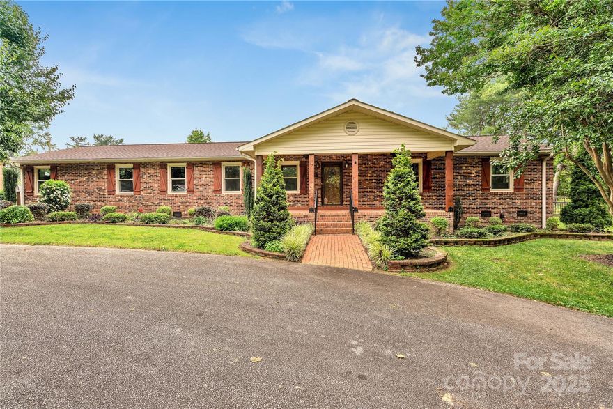 Sprawling 3 bedroom, 2 1/2 bath brick ranch situated on one acre in a peaceful setting. 32'x'24' workshop with power & water, an entertainment pavilion, discreet RV and boat storage, and a playhouse. New LVP flooring (2023), gorgeous wooden beams and gas log fireplace, eat-in kitchen, mudroom and spacious laundry room with generous custom cabinets. The bright and airy sunroom with adjacent powder room will likely become your favorite space to relax, overlooking the beautiful brick patio. The entertainment pavilion features a stone gas fireplace and was custom built for hosting events small or large. The adjacent outdoor kitchen, barbeque and bar make those special times even easier. The workshop provides a third garage space with plenty of room for projects and storage. There's additional covered parking, a second covered shed and 2-story playhouse. The spacious owner's suite has a walk-in closet large enough to accommodate an island. New windows 2023. Quiet, serene & central location.