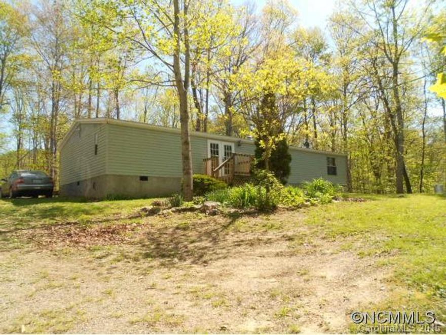A Nature Lover's Paradise. This home has 2+ acres and is surrounded on three sides by woods. 3 bedrooms, 2 baths, split bedroom plan with large bedrooms, kitchen has tile countertops, bathrooms are updated with tile. Enjoy the peaceful outside by the bonfire area or on the nature trails.  There is also an outbuilding.
