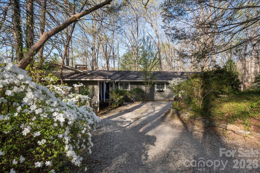 Tucked away in a secluded neighborhood, this mid-century home is a graceful example of legendary architect Holland Brady's penchant for combining nature and design.  The living room boasts an invisible corner of windows, showing off the majestic western mountain views, while the dining room and primary suite use glass sliding doors to let you enjoy the beauty of the lush, wooded property.  Everything you need is on the main level--garage, laundry, bedrooms, bathrooms, and more.  The fully finished basement can be living quarters, storage, or hobby space.  Only 20 minutes to Hendersonville, 10 minutes to Tryon International Equestrian Center.  

Come see everything that this elegant property and the area have to offer!