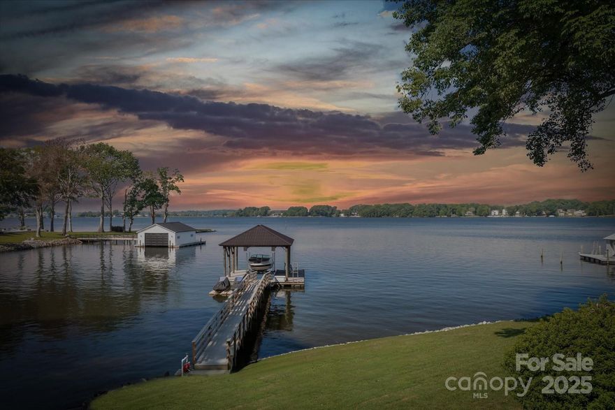 Vintage Charm Waterfront retreat w/expansive views & incredible outdoor living! Enjoy the spacious covered deck w/stone wood-burning fireplace & chandelier for evening entertaining ambience. Each evening brings a new masterpiece as the sun sets across the water—painting the sky with ever-changing colors. Newer Pier w/synthetic decking & lift, dual jet-ski ports & grandfathered boat ramp. Lovingly cared for & updated throughout the years with hardwood floors through main-level living, primary w/step-in tiled shower, updated kitchen w/soft-close cabinets, gas range, pot-filler, granite, & pull-up eating bar. Large Rec Room downstairs features beverage fridge, quartz counters, sink, dishwasher, full bath & flex "bunk room." Central lake & land location along the western shores of the Brawley Peninsula make this location unparalleled. The 35 acre nature preserve & public ramp just 1/2 mile is a bonus. No Restrictions, a rare chance to own your front-row seat to nature’s most stunning show!