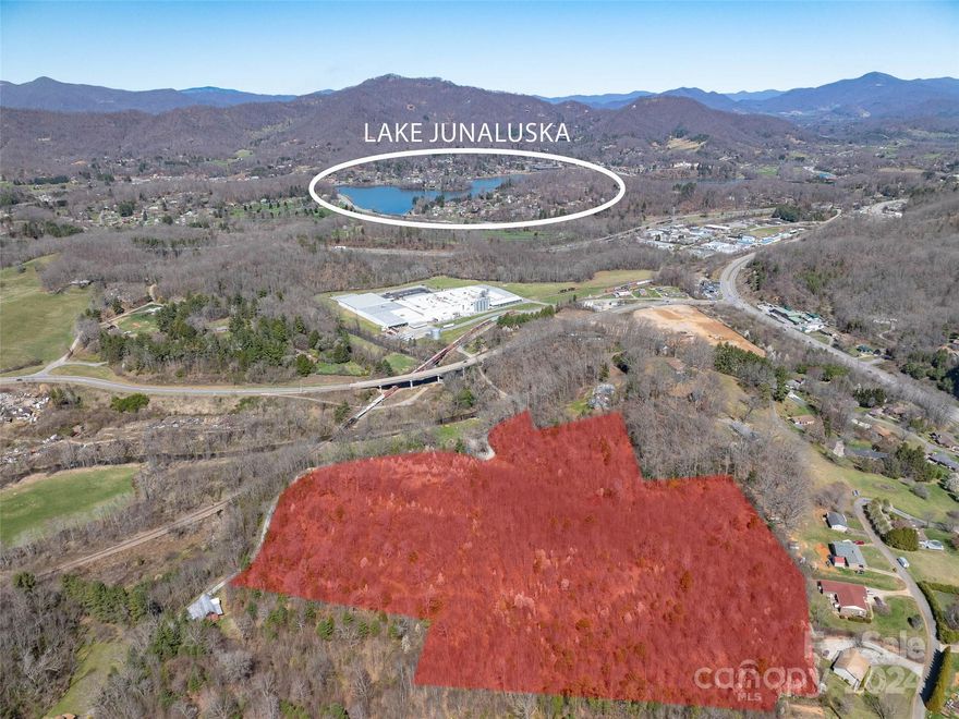 Beautiful 19+ acres of unimproved rolling acres with easy access and spectacular long range year round views between downtown Waynesville and Lake Junaluska exit 104 with many possibilities such as multi family, subdivision or private estate. Water and sewer are on site, however to be verified and confirmed with needed use from town of Waynesville.