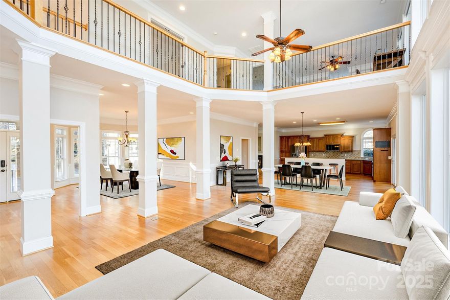 Luxury lake life awaits! Step inside to beautiful hardwood floors and be immediately drawn to the wall of windows that showcase palm trees, a covered dock with boat lift, keystone retaining wall and views of Lake Wateree.The kitchen features a double wall oven, gas cooktop, granite counters and custom cabinetry. An open great room with 2 story windows and a cozy gas fireplace provide a place for guests to gather and enjoy.The primary has a huge walk in closet, en suite with double vanities, tile shower, towel warmer and soaking tub.As you ascend the beautiful wrap around staircase, there is an exposed catwalk looking over the family room and leading you to four more large bedrooms, an office area and second den with huge walk in attic storage closet. Outside, the deck has a 2 story covered porch and a "grilling gazebo" that's sure to be the spot for lake fun. A paved drive and double garage finish off this perfect lake home. Schedule a tour and see why this home should be yours today!