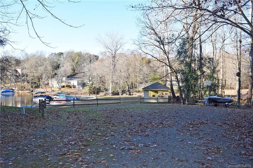 Location! Location! Location!  Lovely homesite in a lake community, just over an acre with topography well suited for building.  Enjoy access to the lake, with community boat slips nearby. Super convenient to uptown Charlotte, shopping, restaurants, and the airport.  Ready to build: the well has already been installed, saving you time and expense.  Excellent value  and opportunity to enjoy the lake without the big price tag!
