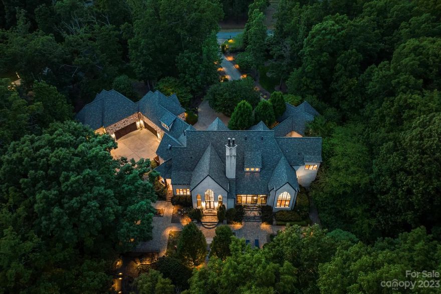 "Nothing To Wine About" ~ This gated English countryside manor is nestled on over 6 wooded acres in The Sanctuary. Old world details & the craftsmanship of custom home builder, Arcadia. Home overlooks traditional English gardens backed by wooded landscape creating spectacular views. Arched ceilings frame the large Gothic windows, creating light filled rooms. Brazilian walnut hardwood floors flow through this home designed for entertaining & comfortable family living. Chef inspired kitchen with Viking appliances, custom island opens to breakfast, great room & formal dining. Main level primary suite overlooking the rose garden. Covered walkway leads to the guest house w/vaulted ceiling, kitchen & full bath. Stunning english gardens out back with stone walkway & babbling brook leading to the absolutely incredible wine cottage like no other holding 1700 bottles of your favorite wine! Enjoy outdoor living in total privacy w/ in-ground fire pit & so much more on this 6 acre wooded sanctuary!