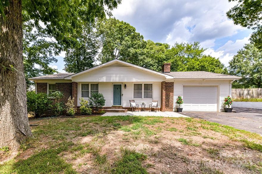 Cute ranch with 3 beds/2 baths on over 1/2 of an acre in a quiet neighborhood.   24 x 35 Garage-door is 12 or 14 feet in height for RV or auto/workshop(840 sq ft).  Brand new carpet, kitchen cabinets painted w/new hardware, master bath has tiled shower, newer vanities and toilets in both baths, open floor plan and den has a gas log fireplace(gas not connected).  Sunroom equipped with a vent from the HVAC and ceiling fan -- on the other side of the laundry room, there is spacious storage room. Back yard has privacy fence with two gates - can drive through both. Attached 1 car garage w/garage door opener. Roof 2022; HVAC 2015; Water heater just replaced. Owner has filed application to connect to city water and sewer.  Located just around the corner from shopping and dining and only a few miles from Concord Mills.