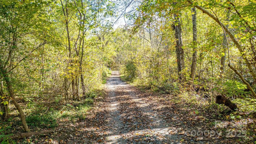 This is your chance to own nearly 27 acres of mountain land on Dodd Road in Barnardsville. The property is wooded with mature hardwoods, rolling topography, and ridgelines that offer a few select possible home sites. The North Fork of the Ivy River borders the south side of the property, giving you ownership on both sides of the water. The property didn’t have any flooding from Hurricane Helene. It’s a private tract with plenty of space to enjoy and shape to your vision.

Whether you’re planning a full-time residence, a weekend retreat, or a few select home sites for family, this land provides flexibility. Selective clearing could open up beautiful long-range views, while the forested setting is ideal for privacy, hiking trails, gardens, or simply enjoying the outdoors.

Just a short drive from Asheville, the Blue Ridge Parkway, and Pisgah National Forest, this property keeps you close to both nature and city conveniences. Buncombe County’s Open Use zoning (buyer to confirm) allows a wide range of possibilities, from residential to agricultural or investment use.

A rare opportunity to create your own mountain lifestyle in Western North Carolina.