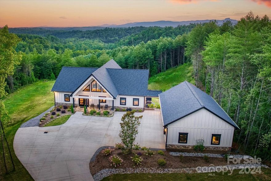 The stylish comforts of 21st century living and the outdoor splendor of the Blue Ridge Mountains, this modern mountain home offers the best of both worlds.  Exquisite lux interiors.  Vaulted wood+beam ceilings, 3 floor to ceiling stone fireplaces.  Gourmet kitchen: hickory cabinets, full size fridge and freezer, warming drawer, beverage chiller, pot filler, designer counters+lighting. Screened porch w/fireplace, outdoor kitchen. Primary Ensuite BR on main with fireplace, spa bath with copper soaking tub, double vanities,beautiful step in shower.  2 BR and full baths downstairs in walkout basement. Family room with fireplace, live edge wood bar, opens to patio facing the sunset view. Outdoor fire-ring ready for those cool autumn nights.  4+ acres with 3 car garage with stone epoxy floor. Poured concrete foundation. Large utility room with dog wash station. Multi-purpose safe room with security door.  See list of features and amenities! At The Coves Mountain River Club.
