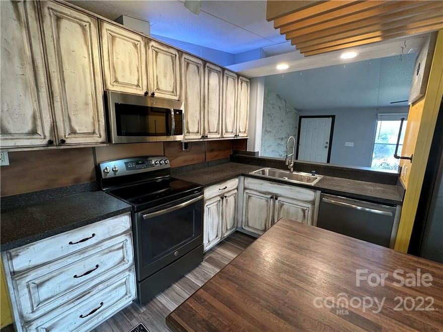 Live on the Cul-de-Sac! Walk in the front door to your Open Concept Living Room/Kitchen/Office with a Walk-In Pantry. Primary Suite with built-ins, walk-in closet and primary bath with walk-in shower. 2nd bedroom with full bath in hallway offering a tub/shower combination. Laundry Room/Mudroom located at back door leading to the large covered deck.  Other outdoor features: sauna, outdoor shower and storage shed. Back yard plantings: Lots of perennial plants & wooded area for backyard adventures. Approximate Heated Square Footage: 1188, 2 Bedroom/2 Full Bath.  Acreage: .55 Approximate Lot Dimensions: 70x251x234x141 Upgrades in home/deck added/sauna-outdoor shower added without permits. Privately Maintained Road/House on Cul-de-Sac Schools: Dudley Shoals, Granite Falls, South Caldwell
Convenient Commuter Location: Hudson to Blowing Rock 26 miles, Hudson to Hickory 12.3 miles. See NCDOT website for Hwy 321 expansion project information.