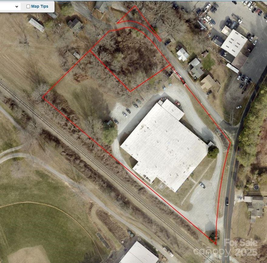Prime location on a hill overlooking Patton Park and the Ocklawaha Trail in the rapidly developing section of Henderson County, just outside of the Hendersonville City Limits, but still near downtown Hendersonville.  Two parcels included, Tax Pin# 9569644321 & 956944182 for a total of approximately 3.55/ac.  The property is mostly level with lots of area for parking around the building and an expandable parking area behind the building.  The main building had a new roof installed in 2021.  The main building is 32,400/sf with 2,700/sf of office area for a total of 35,100/sf.  Building has 2 truck docks and a roll-up door in the main building with 12' ceilings.  Many possible uses in this high growth area. Call the listing agent for all showings.