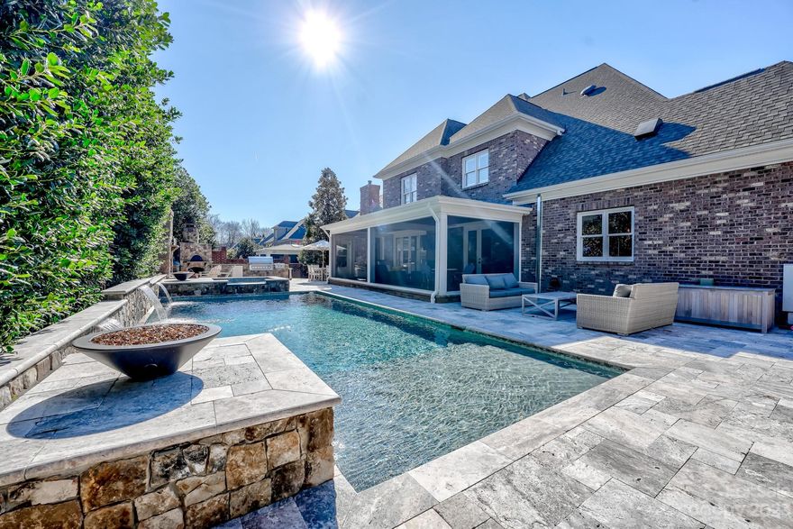 Indulge in opulence in prestigious Stonecroft with this exquisite 5-bed, 6.5-bath estate. Elegance abounds with a designated dining room and an office. Unwind in the main floor master with fireplace & vaulted ceilings. Luxurious master bath features designer finishes, 6x7 shower with 4 heads, & his + hers closets. Entertainment thrives with a 3rd-floor movie room, wet bar, and bathroom. A bonus room adds versatility. Remodeled kitchen and butlers pantry boast designer appliances and quartz countertops. This tech-savvy paradise offers audio throughout, a wine cellar, and a screened porch. Outdoors, a 2021 pool with custom stone retaining wall, waterfall, built-in kitchen, pizza oven, & fireplace awaits. The 3-car garage, new roof, & water heater (2022) reflect commitment to quality. Additional features: updated HVAC, 10-ft ceilings, prime cul-de-sac location. A rare opportunity for meticulously curated luxury living. Your dream home awaits. Ask your realtor for full list of upgrades.