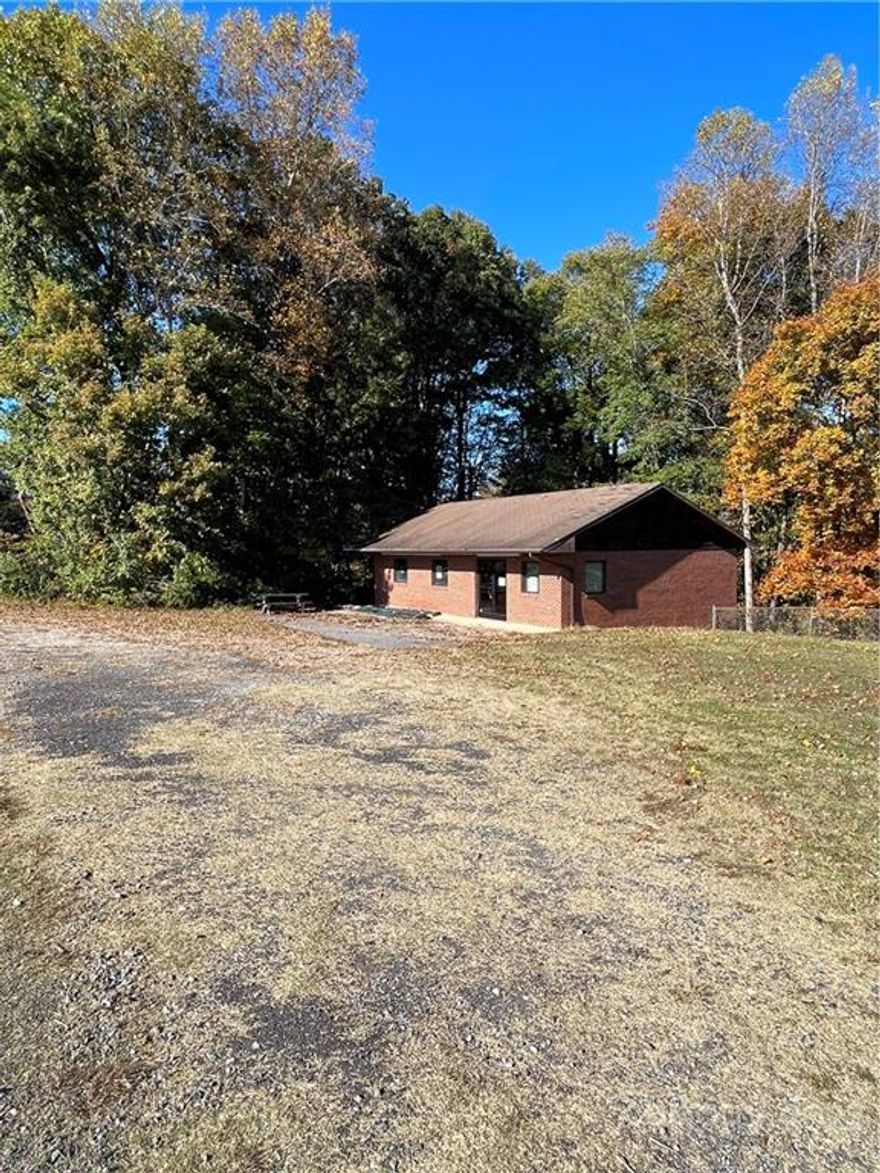 Opportunity for many different possibilities.  Has been convenience store, karate studio, and day care center in the past.  Zoned general business.  Property being sold AS-IS.  Seller is not making repairs.  A survey was done and is in the process of being recorded.  This sale includes approximately one acre from a larger tract.   In process of being recorded.