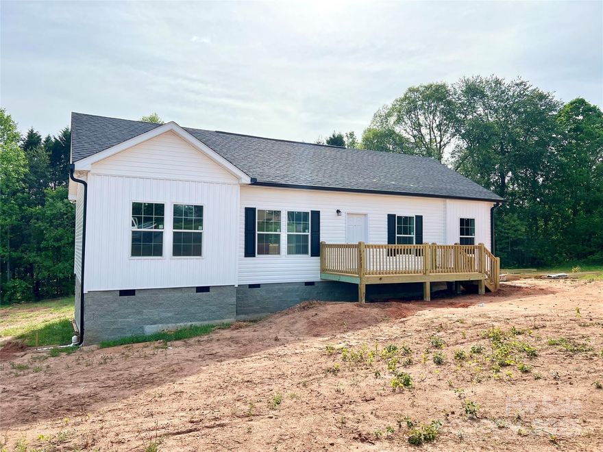 This newly constructed 3BR/2BA property, situated on over 3 acres in the Sugarloaf community of Alexander County is move in ready. Open floor plan, featuring island kitchen, all stainless steel appliances incased by all white cabintry with recessed lighting. Primary bedroom features a shiplap accent wall.
