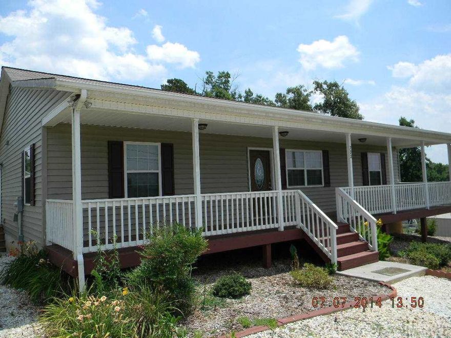 Like new ranch home with full basement and full length covered front porch.  Home has split bedroom design.  Kitchen has Granite counter tops and stainless steel appliances including Range, Dishwasher and Microwave.  Convenient Laundry Room with external access to the wrap around decking. Easy care laminate flooring in the living and dining rooms, with ceramic tile entry ways. Kitchen and bathroom floors are ceramic tile.  Home is in great condition.  Full basement is plumbed and has ductwork already there, so it would be easy to finish. External access from basement to back yard.  Level paved parking area in front.  Location is great with easy access to I-40 or town and shopping.  City water and sewer.  Duke Power. View the mountains in the distance from your rocking chair front porch! A great home awaits you.