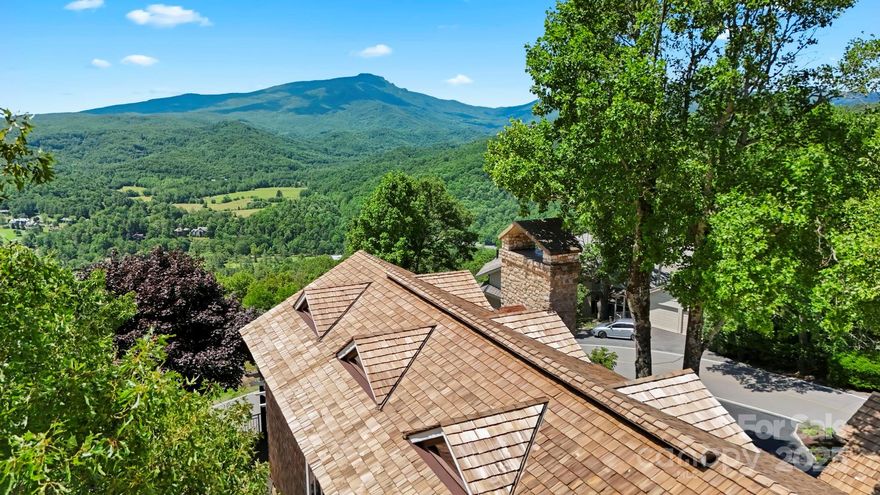 Luxurious mountain home w/ 1-level living- great full-time residence, getaway, or investment w/ ST rentals permitted (w/ registration process/restrictions). This 3 BR/3.5 BA estate is offered furnished & rests on a combination of 3 lots. Enjoy beautifully landscaped grounds & long-range, layered views including Grandfather Mtn & Seven Devils! Main level features great room w/ cathedral ceiling, exposed beams, wall of windows, & 2-story fireplace—adjacent to dining room & kitchen w/ SS appliances, granite, pantry, & wormy chestnut floors. Spacious Ipe deck accessible from multiple rooms. Main-level primary suite offers deck access, 3 walk-in closets, tiled shower, & soaking tub. Also on this level, find a 2nd BR/BA suite with tiled shower, foyer, half BA, & laundry room w/ sink & storage. Upstairs, find a lofted living area overlooking the great room, 3rd BR w/ vaulted ceiling, & 3rd full BA. Circle drive & port-cochere provide easy access to attached 2-car garage & golf cart garage.