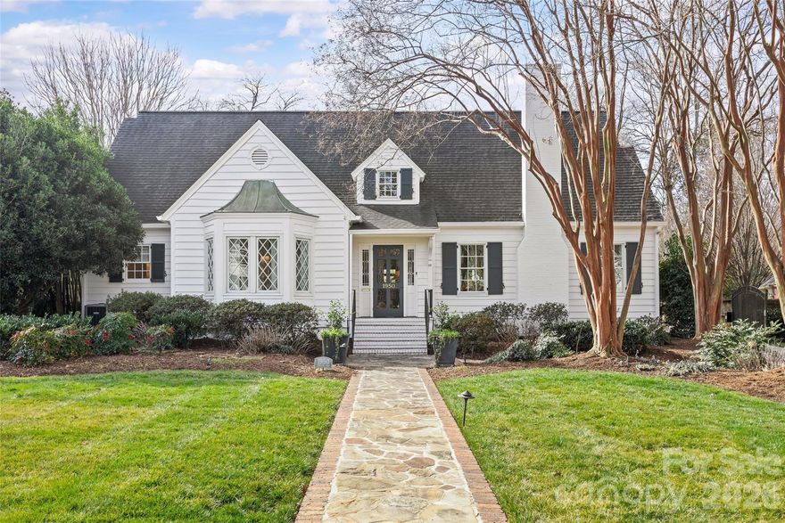 Welcome to 1950 Sterling Rd, a beautifully updated 5BR, 4.5BA home set on a rare .51-acre lot in the heart of Myers Park. Offering 4,200+ sq/ft of refined living space, this charming cottage blends timeless architecture with elevated, designer finishes throughout. Pristine landscaping and inviting curb appeal lead to a light-filled interior featuring 9’ ceilings, hardwoods, intricate moldings, and gracious formal and informal living spaces. The renovated white marble kitchen with high-end appliances, abundant custom cabinetry, and walk-in pantry opens to a sunny breakfast area with built-in banquet and spacious family room overlooking the backyard. Stunning scullery with marble countertops, pebble ice maker, and beverage fridge adds both style and function. Main-level primary suite offers a spa-like marble bath and custom walk-in closet, while upstairs includes four additional bedrooms all with direct en-suite bath access, and a flexible loft/play space. Exceptional outdoor living on the covered blue stone porch with outdoor fireplace, built-in heaters, and grilling station (added 2024) which overlooks the incredible heated saltwater pool with spa and huge fenced yard. Unbeatable in-town location, this is truly a special home you do not want to miss!