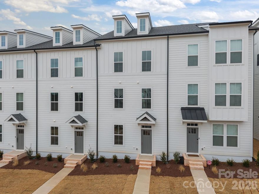 Welcome to The River District—a true master-planned community designed for the way you live, work, and play.

This beautifully appointed Landon three-story townhome offers exceptional flexibility and style. The main level features a spacious flex room—perfect for a home office, game room, gym, or creative studio.

Upstairs, the heart of the home shines with a gourmet kitchen showcasing quartz countertops, a built-in oven and microwave, electric cooktop, and soft-close cabinetry. The open-concept dining and living areas provide an inviting space for entertaining, with sliding glass doors leading to your private balcony—ideal for morning coffee or evening relaxation.

The third level hosts a serene owner’s retreat, complete with a bright and airy bedroom and a spa-inspired bath designed for ultimate comfort. Two additional bedrooms, a full bath, and a conveniently located laundry area complete the upper floor.

Every detail of this home has been thoughtfully curated, with interior design finishes individually hand-selected by our professional design team.

Location truly sets this home apart. At The River District, you’re just minutes from everything you need. The community will feature resort-style amenities including a pool, clubhouse with fitness center, tennis and pickleball courts, parks, scenic trails, a working two-acre farm with an on-site farmer, and a stunning riverfront amphitheater.

Experience elevated living in a vibrant community where convenience meets connection.