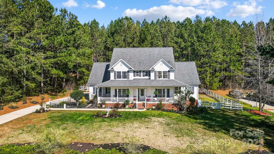 Nestled in the serene & picturesque Wild Pine community, this charming 3bed, 2.5bath home sits on a generous 1 acre lot. The rocking chair wrap-around porch invites you to relax & enjoy the peaceful surroundings. The spacious primary bedroom & en suite are conveniently located on the main floor, offering privacy & comfort. Upstairs, you'll find 2 additional bedrooms, a full bath & large bonus room currently used as a bedroom. The home also features well-established gardens w/ stunning perennials ready to bloom, adding natural beauty to the property. A screened-in back porch & additional covered porch offer even more spaces to enjoy the quiet of nature. The fenced yard provides ample outdoor space, though it doesn't encompass the entire backyard, giving you room to expand. Other highlights include walk-in closets, mudroom & laundry room on the main floor. Conveniently located near Lake Wylie, downtown York & Newport, this home is within the desirable Clover School District.