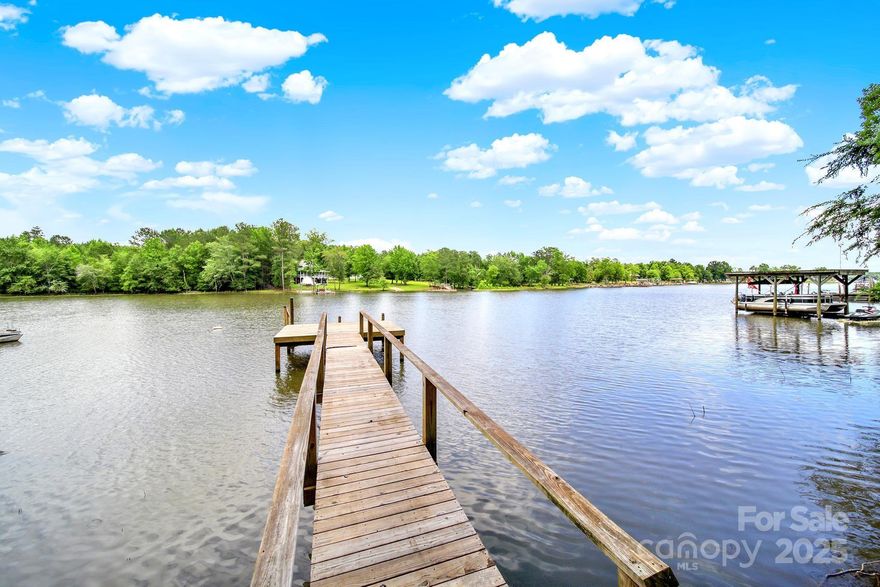 Realize your waterfront dreams in this exquisite home in the Liberty Hill area of Lake Wateree. This home has great water views from living area, bedroom and porch where you can enjoy your morning coffee or watch the evening sunset. You’ll love the kitchen remodeled in 2019 with new cabinetry, granite countertops and new appliances. Have your family gatherings in the basement recreation room with fireplace and exit onto the concrete patio for grilling and entertaining. Cool off in the in-ground salt water pool or experience the lake life from your private boat ramp and pier. Park your vehicles in the attached carport and all your outside equipment in the storage area of the walk-out basement and detached building. Fireplaces in den and recreation room have gas logs and fireplace in bedroom is wood burning. All furniture and accessories negotiable.