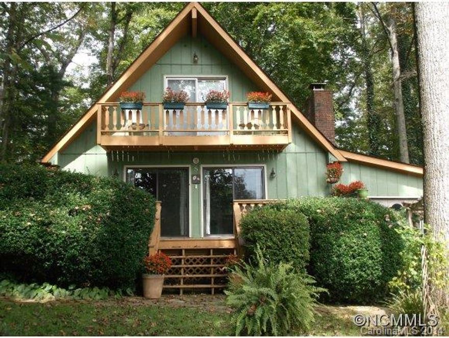 Your mountain retreat is on Scott Lane. Perfect place to live and relax; a highly desirable neighborhood friendly to people, children, and pets. Convenient to Hendersonville, Asheville, and Brevard. Views from wrap around decks, family room with stone fireplace, sunroom with a private yard. Garage, storage area, and carport. Exterior recently stained. Great price reduction. Check this out!