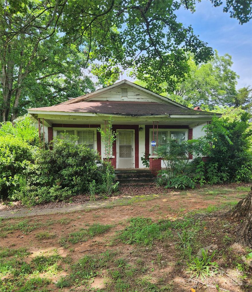 This property is a unique 3 bedroom, 1 bath home located on almost 2 acres of green lush land.  The property lines run along the front & back side of the property and extends across Tot Dellinger Road. The land contains fruit trees such as peaches, pecans, black berry and black cherry trees.  This is a distressed property that is in need of a lot of TLC.  The perfect buyer would be someone with a background in construction or an investor.  This property has a lot of potential.  Are you up for the challenge?  This property is being sold as is.