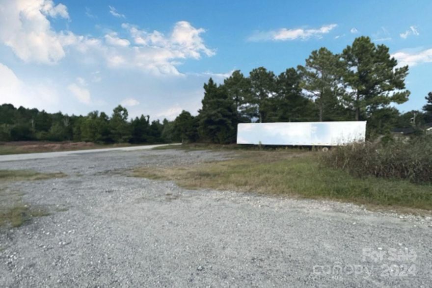 This prime commercial land offers a strategic location right off the bypass, ensuring visibility and easy access. It has excellent accessibility for transportation and logistics. The land is fully fenced, ensuring secure operations and protection of assets with a large gate, with barbed wire. A robust concrete pad is already in place, making it suitable for a building or business. There is flexible zoning at this location, and it could be used for many different types of businesses. Additionally, the site features an on-site road, enhancing the ease of movement within the property. This prime location is perfect for businesses seeking a well-equipped and strategically positioned commercial site. There is already a concrete slab in place that could be used to place a building for storage or use. Anything not affixed to the property will be removed prior to closing including trucks, trailers and tanks. Approx. 1.3 mi from I-77 exit. Public utilities accessible at this location.