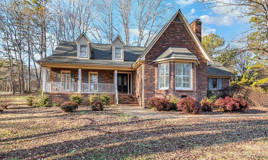 Just reduced below tax value for a quick sale! Welcome to this stunning brick home that boasts 3400 square feet of living space on an acre lot in an beautiful, established neighborhood! The great room features a tall cathedral ceiling with exposed wood beams and a raised brick hearth. The chef kitchen is a dream come true with its wood floors, 6 burner gas cooktop, center island with prep sink, and double ovens. The breakfast room has a convenient wet bar. The master bedroom is located on the main floor for easy access and privacy, upstairs are an additional 3 bedrooms plus an oversized bonus room currently being used as a bedroom.  A delightful sunroom and a formal dining room complete this amazing home. Some TLC is needed to make it shine again. With an acceptable offer, the seller will include a 1-year home warranty not to exceed $600. Don't miss out on this opportunity to make this your forever home!