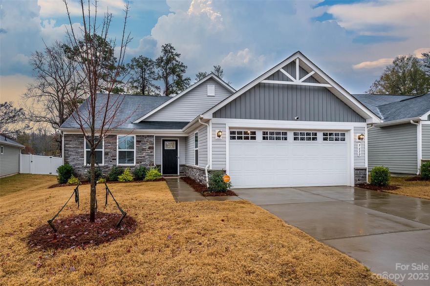 Seller has a 2.75% assumable VA loan and also this property qualifies for a grant program offering closing costs and down payment assistance.  Split bedroom floor plan with primary bedroom separate from the secondary bedrooms.  Stylish cabinets with rollouts, upgraded quartz countertops, wide plank flooring throughout the living areas, tiled baths, and laundry room work sink.  Open layout with lots of lighting, remote-controlled shades, wifi enabled thermostat, deep garage with work bench niche and freshly epoxied floor  All SS kitchen appliances.  Fridge, washer & dryer remain.  Enjoy outdoor living on the screened porch with a grilling patio with a treed view.  Nicely landscaped, full privacy fence, backs up to common area.  Low-maintenance living with lawn care included in the HOA dues.  Great location on a low traffic, dead end street.  Just 2 miles from I-485, which puts you minutes from Harrisburg or Mint Hill, and will get you anywhere you need to go within the Charlotte area.