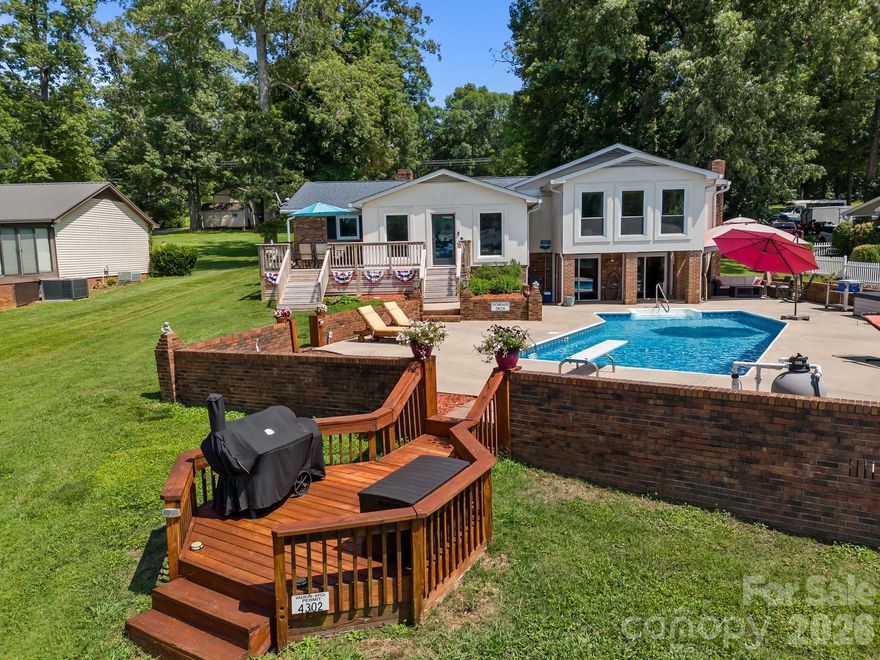 Welcome to your dream house on High Rock Lake, located in a wide cove on Abbotts Creek. This stunning lakefront property boasts an array of luxurious features designed for comfort and enjoyment. This split-level, updated home features 3 spacious bedrooms, 2 full bathrooms, an open floorplan and a walk-out finished basement. There are 2 sunrooms offering space to relax and soak in the natural light with the brand new, large windows throughout, providing breathtaking views of the lake. This house offers the best of both worlds with an inground, saltwater swimming pool that's perfect for cooling off on the hot summer days. The back deck is perfect for entertaining and simply enjoying a peaceful evening watching the sunset. For your parking and storage needs, the property includes a large driveway, a 3 car detached garage, an attached 1 car carport, and a detached 3 car carport (one has space for RV parking & hookup). This house on High Rock Lake isn't just a home, it's a lifestyle!