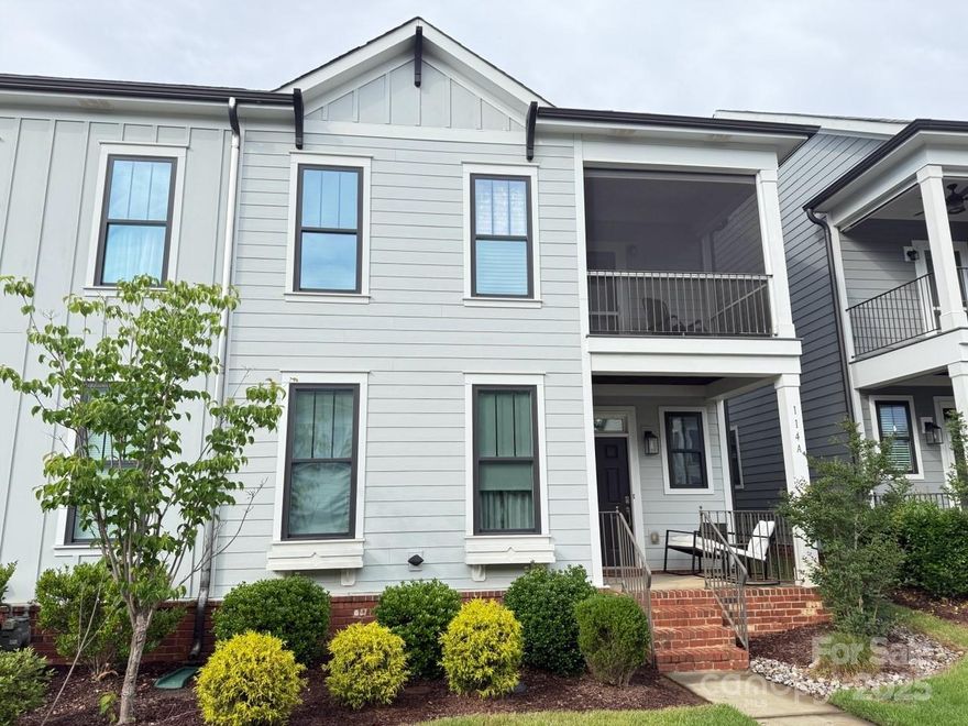 Step into this beautifully first floor primary bedroom maintained end-unit townhome featuring a low-maintenance fenced yard with lush artificial turf, perfect for relaxing or entertaining. The main level primary suite offers convenience and comfort with access to a covered patio featuring a retractable screen, blackout automatic shades and custom closet.  Additional upgrades include surround sound in living room and a pre-wired security system with camera.  Open-concept main floor includes a great room with built-in storage and a pristine kitchen with granite countertops, stainless steel appliances, large island and ample cabinetry. Upstairs, you'll find a versatile loft area, two additional bedrooms and access to a private screened balcony, perfect retreat. The two-car garage is upgraded with custom epoxy floor and built-in workbench for your special projects. Located just minutes from popular shopping and dining options. This home blends comfort, convenience, and style. WELCOME HOME!