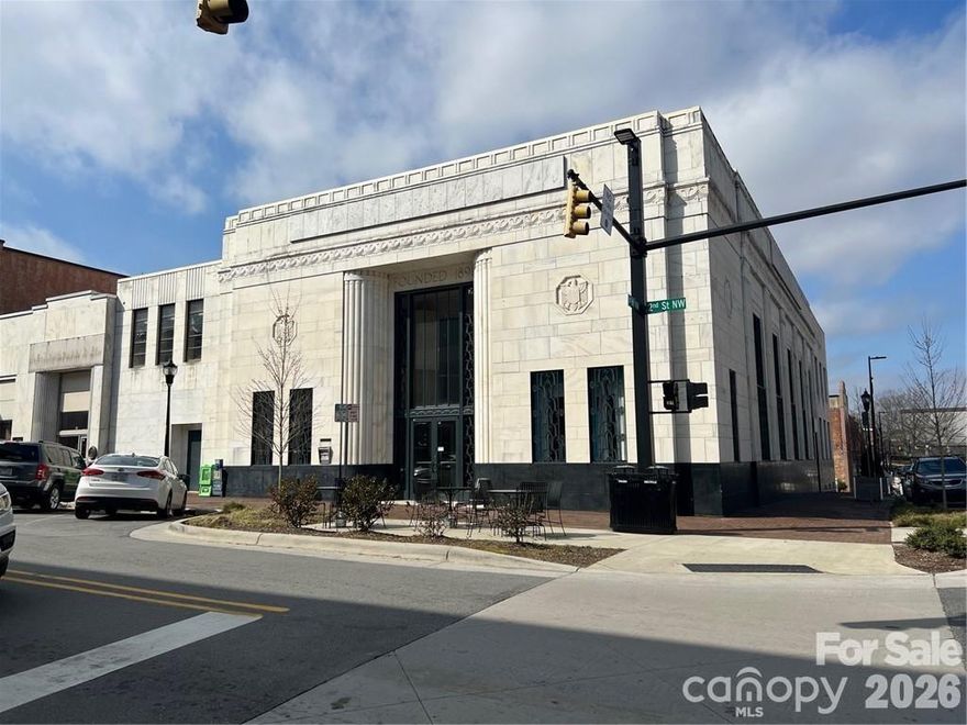 This stunning building located in Downtown Hickory on the corner of 1st Ave and 2nd St NW is available for sale. The 23,065 square foot building has 10-26' foot ceilings, multiple offices, a full kitchen, gorgeous large windows, and ample storage space on the lower level. Located in the new Downtown Social District. Brand New Roof installed in 2021. City parking is available right near the building and is extremely close to many great businesses on Union Square. Owner began developing a town hall food center and added wet sprinkler system . We have architectural plans for this development