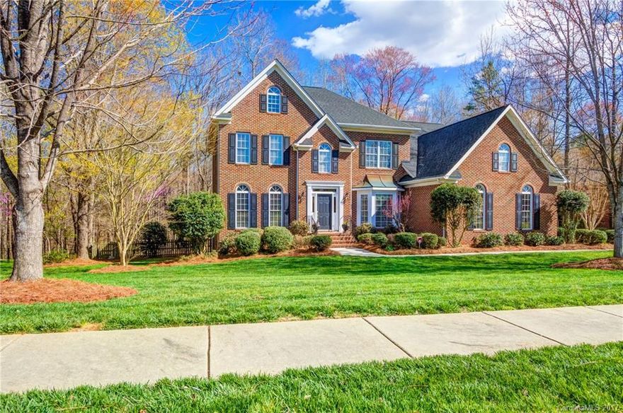.8 ACRES & FULL BRICK!!! Hardwoods floors throughout Up & Down! Fenced yard. 3-CAR sideload! Dual staircases w/hardwood treads +wrought iron balusters. Cook's Kitchen w/STAINLESS APPLIANCES! 5-burner gas cooktop+double ovens+microwave + granite countertops, tile backsplash, island w/counter seating+casual dining, walk-in pantry+Butler's Pantry w/glass upper cabinets! Great Rm w/gas fireplace, Dining+LivingRm/Study. NEW Roof +Shutters(2011) +Water Heater(2014). Walk to Pool+Playground+Sport Field