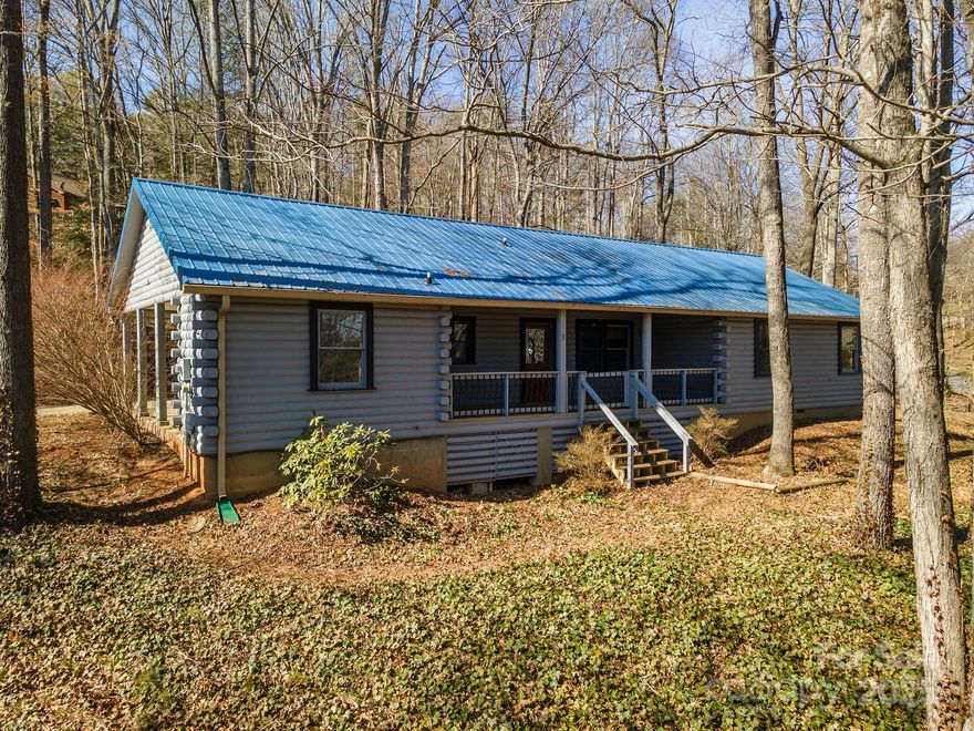 Discover the perfect blend of privacy and convenience at 9 Red Oak Mountain Rd in pastoral Weaverville. This charming one-level, log cabin home features an open floor plan with vaulted ceilings, a covered front porch, and a fenced backyard for pets. Situated on a desirable 0.77-acre lot in a quiet neighborhood, it offers both tranquility and community. Just 10 minutes from downtown Weaverville, less than 20 minutes to Asheville, and 35 minutes to the airport, this home provides peaceful living with easy access to city amenities. *Note - While a chimney inspection from 12/2019 did not show any hazardous defects, there were some noted deficiencies and the inspector recommended upgrading to a new woodstove insert with stainless steel liner, pouring new crown on top, adding stone/brick veneer over exterior stucco, and repairing roof flashing. The sellers tightened up the flashing at the time but did not have it replaced. They have had no known issues when using the woodstove.