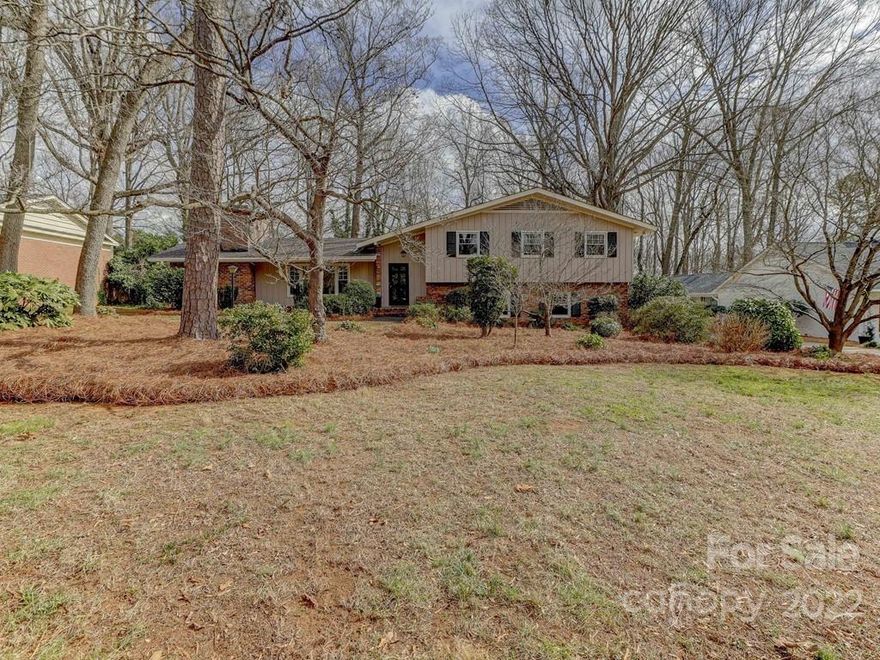 Don't miss this classic Mid-century 4BR/3BTH home with endless possibilities awaiting the next owner!  Spacious rooms with newer windows throughout, hardwood flooring, beautiful doors and heavy molding anchor this home with amazing opportunity. Two woodburning fireplaces offer relaxing spaces for everyone.  Don't miss the private home office or exercise room off the main dining room.  Eat-in kitchen connects to inviting sunroom with expansive windows overlooking level, private lot with mature tree canopy.  Primary suite and two secondary bedrooms located on the upper level with excellent closet space and large baths.  Guest room with full bath and laundry on lower level.  Huge family room down with bar and built-ins opens to patio with view of rear yard with lush landscaping~ Two outside storage rooms connect to home- Location is minutes to SouthPark, Uptown and offers proximity to excellent public and private schools.  
Bring your imagination and make this one your very own!