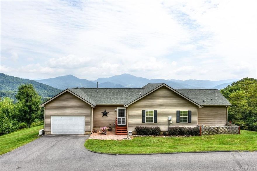 If you're looking for a view, this one is it. Enjoy coffee and cookouts on the oversized deck with totally unobstructed views. This well kept home is one level with wide doorways & hall. Massive windows in great room provides full time views from inside. Master opens to deck & has walk in shower in bath. Hard wired generator. Oversized garage with heat & air condition and nice workshop area. Raised beds with organic soil ready for your garden