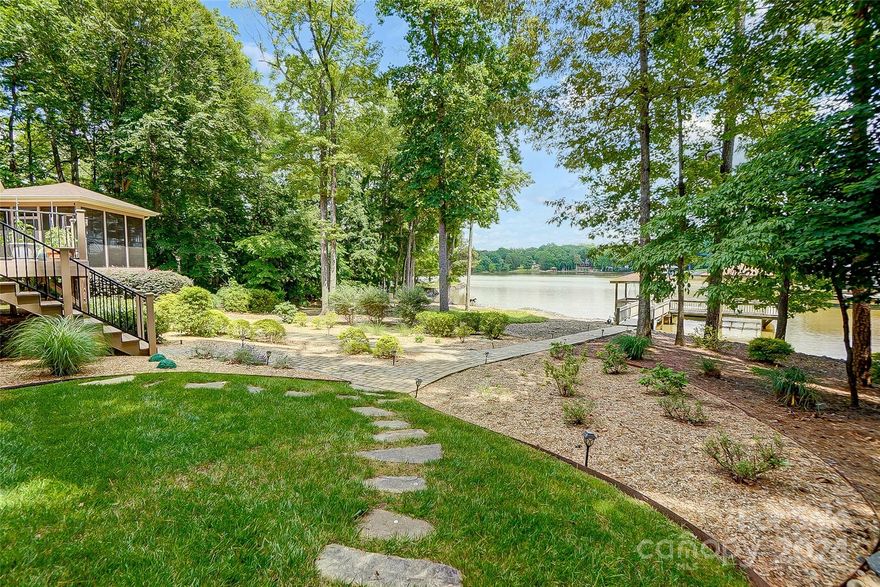 Extraordinary waterfront home on 1.24 acre lot w/ breathtaking views of Lake Wylie. This home has everything you're looking for from a bright & open floor plan, hardwood flooring, rich moldings, arched doorways, vaulted ceiling, 3 car garage, beautiful landscaping, & outdoor oasis! Spacious great room w/ built-ins & fireplace opens to gourmet kitchen offering granite counters, gas cooktop, pot filler, double ovens, large island, pantry & dining area. Formal dining room is perfect for elegant dinner parties or casual gatherings. Luxurious primary suite boasts vaulted ceiling, sitting area & spa-like bath. Home office & 2 BRs complete main level. New 75 gal water htr, 2nd living quarters above the garage w separate entrance, large rec room, 2nd kitchen, 2nd laundry, BR & full bath. Screened porch w/ EZ breeze windows, covered trex deck, spacious level yard, beach area, & covered dock w/lift offer unlimited possibilities for outdoor lake living. Great location, Clover schools, SC taxes.