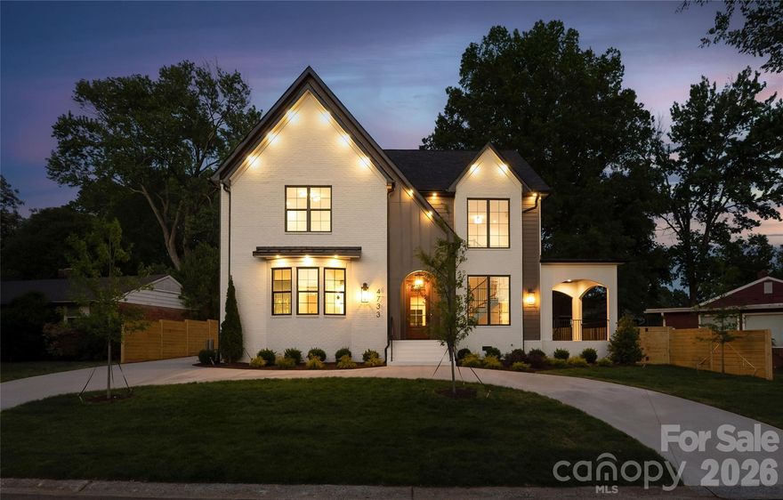 Located in the desirable Madison Park neighborhood, this new construction Signature Series home offers a striking blend of architectural character, designer finishes, and modern luxury. Spanning 3,419 square feet, the residence features 5 bedrooms and 3.5 bathrooms, designed to provide both impressive entertaining spaces and comfortable everyday living.
A dramatic two-story foyer makes a memorable first impression, setting the tone for the light-filled interior. The expansive open-concept main level showcases engineered hardwood flooring, custom trim work, and warm wood beam ceilings, all illuminated by a carefully curated selection of designer lighting that elevates every space. The living room centers around a fireplace and flows seamlessly into the dining area and statement kitchen. Designed to impress, the chef’s kitchen features floor-to-ceiling custom cabinetry with glass display cabinets, a walk-in pantry, gold hardware, premium appliances, and a large island perfect for gathering. A main level powder room and coat closet add everyday convenience.
The main level primary suite is a true retreat, offering generous proportions and a spacious walk-in closet with washer and dryer connection. The spa-inspired primary bath features two separate vanities, a private water closet, elegant green tile, a standing tub, and a large walk-in shower.
Upstairs, a flexible sitting area provides additional living space. The upper level includes a guest suite with a walk-in closet and private ensuite bath, along with three additional bedrooms that share a full hallway bath.
Outdoor living is equally inviting with two separate patio areas designed for both entertaining and quiet relaxation. The rear patio features a cozy outdoor fireplace, creating the perfect setting for evenings under the stars, while the fully fenced backyard provides privacy and space to enjoy the outdoors. A detached two-car garage and circular driveway complete the property, adding both practicality and exceptional curb appeal.
Ideally positioned just minutes from SouthPark, South Boulevard, Park Road Shopping Center, and Uptown Charlotte, this home offers sophisticated new construction living in one of Charlotte’s most desirable locations.