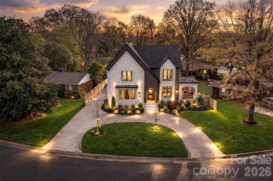 Located in the desirable Madison Park neighborhood, this new construction Signature Series home offers a striking blend of architectural character, designer finishes, and modern luxury. Spanning 3,419 square feet, the residence features 5 bedrooms and 3.5 bathrooms, designed to provide both impressive entertaining spaces and comfortable everyday living.
A dramatic two-story foyer makes a memorable first impression, setting the tone for the light-filled interior. The expansive open-concept main level showcases engineered hardwood flooring, custom trim work, and warm wood beam ceilings, all illuminated by a carefully curated selection of designer lighting that elevates every space. The living room centers around a fireplace and flows seamlessly into the dining area and statement kitchen. Designed to impress, the chef’s kitchen features floor-to-ceiling custom cabinetry with glass display cabinets, a walk-in pantry, gold hardware, premium appliances, and a large island perfect for gathering. A main level powder room and coat closet add everyday convenience.
The main level primary suite is a true retreat, offering generous proportions and a spacious walk-in closet with washer and dryer connection. The spa-inspired primary bath features two separate vanities, a private water closet, elegant green tile, a standing tub, and a large walk-in shower.
Upstairs, a flexible sitting area provides additional living space. The upper level includes a guest suite with a walk-in closet and private ensuite bath, along with three additional bedrooms that share a full hallway bath.
Outdoor living is equally inviting with two separate patio areas designed for both entertaining and quiet relaxation. The rear patio features a cozy outdoor fireplace, creating the perfect setting for evenings under the stars, while the fully fenced backyard provides privacy and space to enjoy the outdoors. A detached two-car garage and circular driveway complete the property, adding both practicality and exceptional curb appeal.
Ideally positioned just minutes from SouthPark, South Boulevard, Park Road Shopping Center, and Uptown Charlotte, this home offers sophisticated new construction living in one of Charlotte’s most desirable locations.