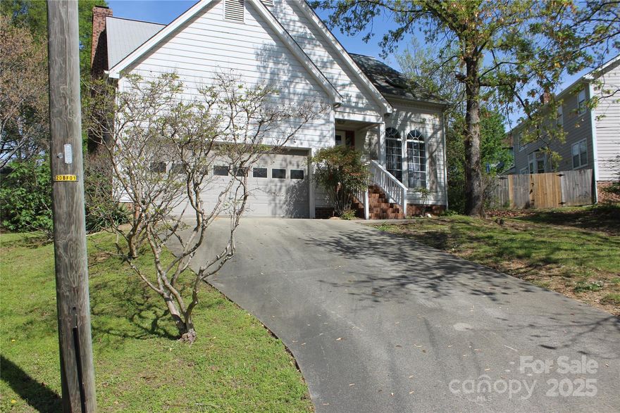 This 1967 sq. foot home features 3 bedrooms, 2 full baths, and a half bath/laundry on main...with an extra large double garage with a wide driveway provides extra parking.  Living room with dramatic high ceiling open to the formal dining area.  Den off kitchen features a wood burning fireplace.  Breakfast nook doors lead to the deck overlooking this large partially fenced yard.  The yard is .56 acres which includes a .29 side lot PID 049-381-38.  Upstairs, the large primary has vaulted ceilings and primary bath features a soaking tub with a separate walk in shower, and a walk in closet with access to extra attic storage.
Being sold as and ready for your TLC to make it yours.