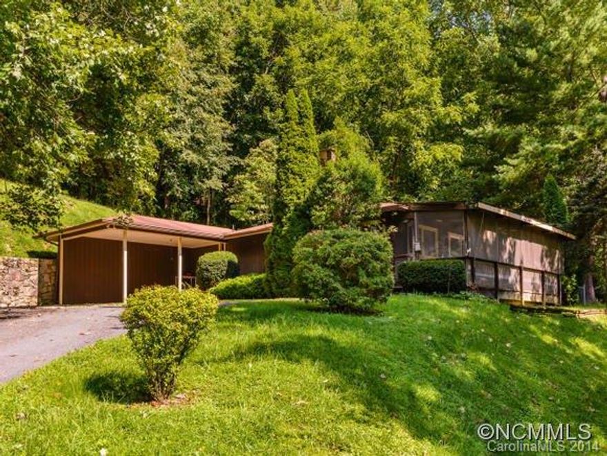 Priced to Sell!! 2 BR 2 Bath home with huge great room with a beautiful rock fireplace.  Lots of cabinets in a very workable kitchen.  Front screened in porch for morning coffee and lazy mountain afternoons. Great location just off of Jonathan Creek. Carport and outside utility for storage.  Fenced yard.  Close to Maggie Valley and Waynesville.  Perfect vacation home!