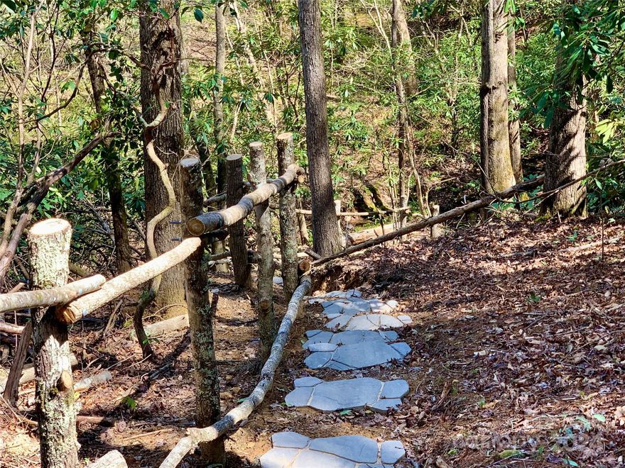 A trail through the woods, past towering hardwood trees, rhododendron and mountain laurel, leads to two streams that ripple through this 4.3 acre property. Located at the end of Tableview Lane, just above Johns River, this lot has a view of Adams Mountain and a gentle sloping build site, perfect for a walkout basement. A community trail passes by the lot on the way to Johns River.  Located at The Coves Mountain River Club, a 3,200 acre gated community in the Blue Ridge Mountains. Private trails to hike, bike, ride horses or UTVs. 5 miles of Johns River on site. Clubhouse: pool, hot-tub, kitchen, fitness center, locker rooms, 360° views of Grandfather Mtn, Hawks Bill, Table Rock, Brown Mtn, Wilson Creek Gorge, Pisgah Nat'l Forest. Community garden, vineyard. 2 Equestrian Centers. Pickle-ball, putting green, picnic pavilions, fire-rings. Dog Park. Socials, trips, yoga, excursions. 30+ enthusiast groups to join! 1.5 hr to Charlotte/Asheville. Mins to Lenoir, Blowing Rock, Morganton.