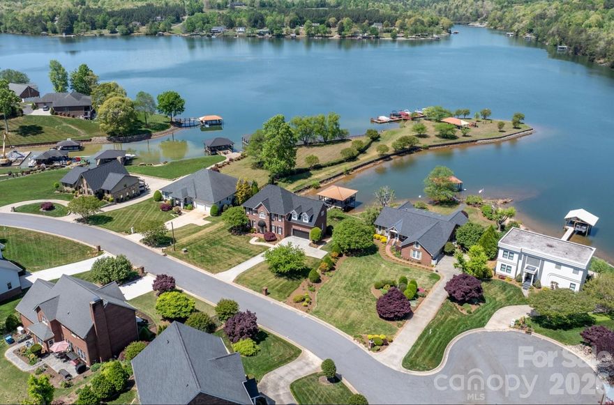 LAKEFRONT, all-brick 3-bedroom, 3.5-bath stately home in a highly sought-after Iswa Point subdivision on Lake Hickory. Immaculately maintained and situated on one of the most level lakefront lots. This home offers breathtaking panoramic water views and beautifully landscaped curb appeal just steps from the shoreline.

Enjoy outdoor living with a covered dock featuring a boat lift, as well as a peaceful, park-like common area that enhances the serene setting.

Recent updates include a new roof (2025), HVAC system (2022), and tankless water heater (2022). The completely renovated eat-in kitchen has been redesigned to create a more open floor plan, showcasing stunning lake views, custom cabinetry, a large island, granite countertops, and stainless steel appliances including a wall oven and range.

The main level also features a cozy family room with a fireplace and lake views, a formal dining room, an additional living room or office, and a convenient half bath. A well-appointed laundry room includes cabinetry, sink, and washer/dryer that remain.

Step into the spacious screened porch—an inviting extension of the home—perfect for morning coffee or evening gatherings while enjoying the lake breeze. 

Upstairs, the expansive primary suite offers a sitting area, fireplace, sweeping lake views, along with two large walk-in closets and a luxurious en-suite bath featuring a tiled walk-in shower, soaking tub, water closet, dual vanities, and makeup area. Two additional bedrooms share a Jack-and-Jill bath, and there is another flex room ideal for an office or additional living space, plus a full hall bath.

Additional features include a double garage with a workbench and built-in cabinetry for ample storage.

Low HOA's and NO CITY TAXES

This home is truly move-in ready—just in time to enjoy summer living on the lake.