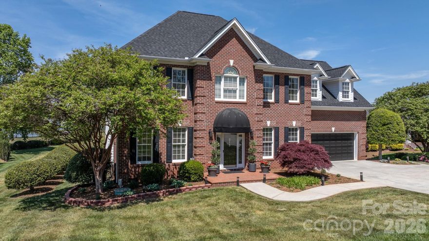 LAKEFRONT, all-brick 3-bedroom, 3.5-bath stately home in a highly sought-after Iswa Point subdivision on Lake Hickory. Immaculately maintained and situated on one of the most level lakefront lots. This home offers breathtaking panoramic water views and beautifully landscaped curb appeal just steps from the shoreline.

Enjoy outdoor living with a covered dock featuring a boat lift, as well as a peaceful, park-like common area that enhances the serene setting.

Recent updates include a new roof (2025), HVAC system (2022), and tankless water heater (2022). The completely renovated eat-in kitchen has been redesigned to create a more open floor plan, showcasing stunning lake views, custom cabinetry, a large island, granite countertops, and stainless steel appliances including a wall oven and range.

The main level also features a cozy family room with a fireplace and lake views, a formal dining room, an additional living room or office, and a convenient half bath. A well-appointed laundry room includes cabinetry, sink, and washer/dryer that remain.

Step into the spacious screened porch—an inviting extension of the home—perfect for morning coffee or evening gatherings while enjoying the lake breeze. 

Upstairs, the expansive primary suite offers a sitting area, fireplace, sweeping lake views, along with two large walk-in closets and a luxurious en-suite bath featuring a tiled walk-in shower, soaking tub, water closet, dual vanities, and makeup area. Two additional bedrooms share a Jack-and-Jill bath, and there is another flex room ideal for an office or additional living space, plus a full hall bath.

Additional features include a double garage with a workbench and built-in cabinetry for ample storage.

Low HOA's and NO CITY TAXES

This home is truly move-in ready—just in time to enjoy summer living on the lake.