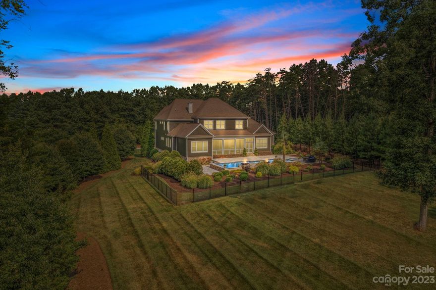 Offer Deadline: 7/26/23 at 2:00pm. This luxury home at The Point @ Trump National sits on 1.6 acres & privacy abounds. Relax by the pool with a view of the 17th tee beyond the beautiful landscaping. Elegant features of this nearly 6000 sq ft custom home include a curving staircase, 3 fireplaces, & coffered/trey ceilings. The open layout seamlessly flows between the great room, adjacent dining areas, keeping room, plus bar & wine room, making it ideal for entertaining. The heart of this home is the gourmet kitchen with 2 islands, 2 dishwashers, 2 sinks, double ovens, & 6 burner gas cooktop. Connect through a wall of glass pocket doors to the screened porch where the pool deck & hot tub beckon. Indulge in the 1st floor primary bedroom w/luxurious ensuite & large walk-in closet. Upstairs boasts a large game room with bar, media room, plus a huge bonus room & home gym, 3 BRS & 3 Baths. Note the 1st floor study & private entrance to the guest studio(in-law suite) w/ kitchenette & bathroom.